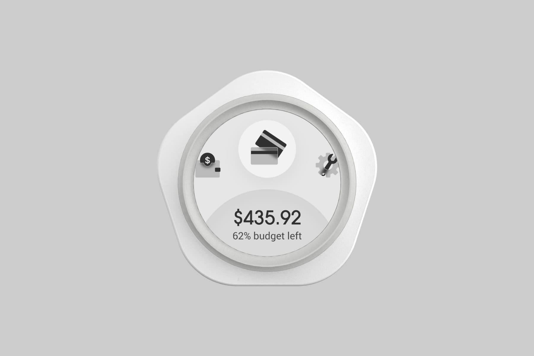 Top-down view of Budgetty. The circular screen at the center of its pentagonal shell displays the home page with the menu and remaining balance.